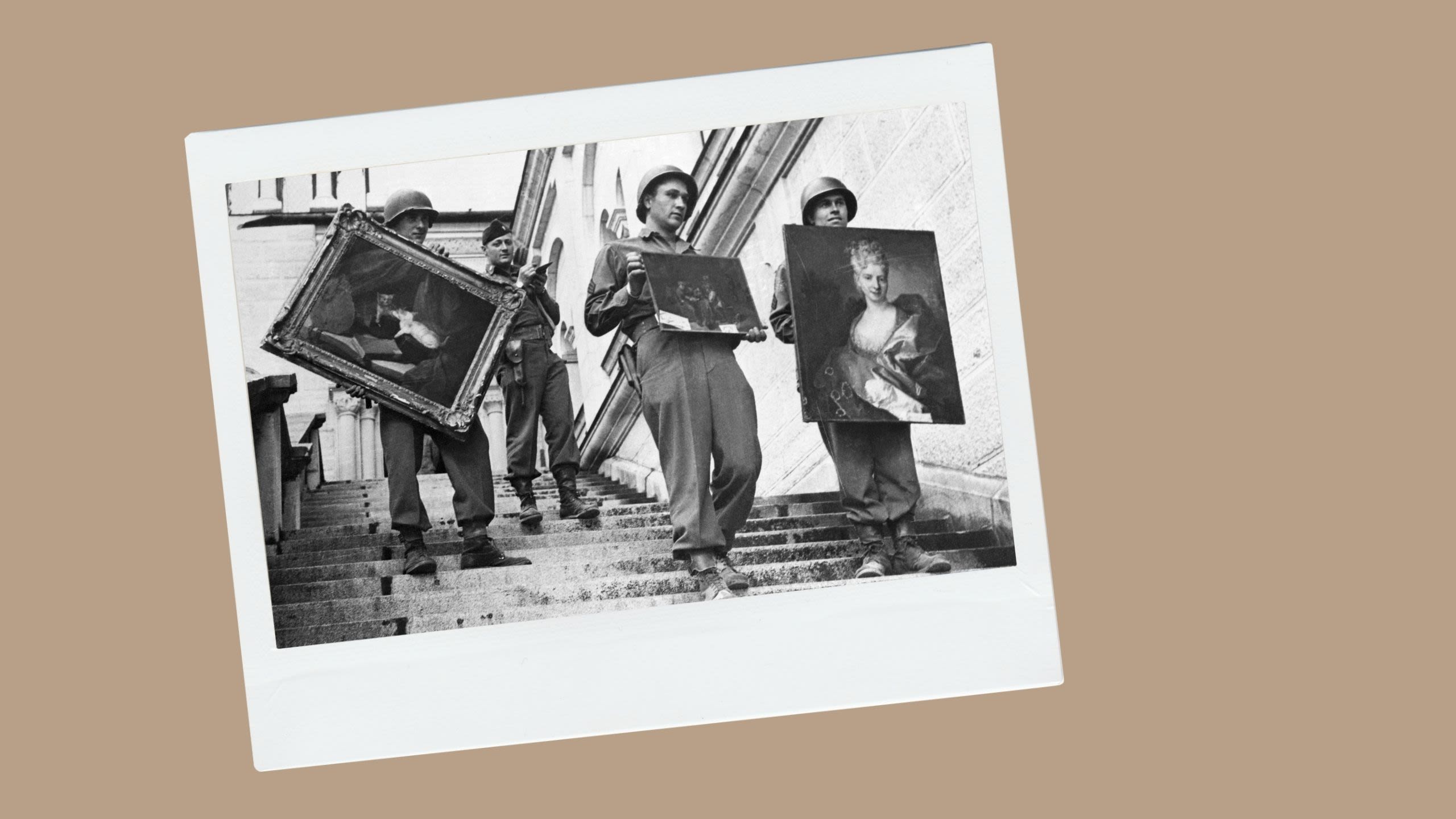 Three soldiers holding valuable works of recovered art (© Bettman/Getty Images)
