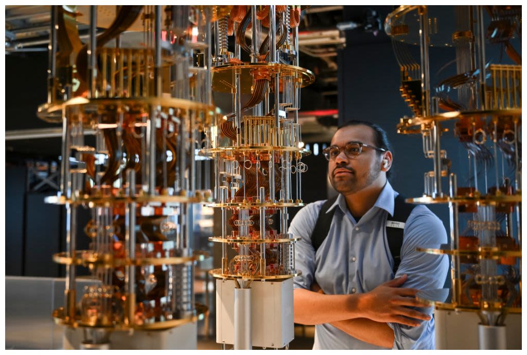 Man examines components of next-generation quantum computer (© Angela Weiss/AFP/Getty Images)