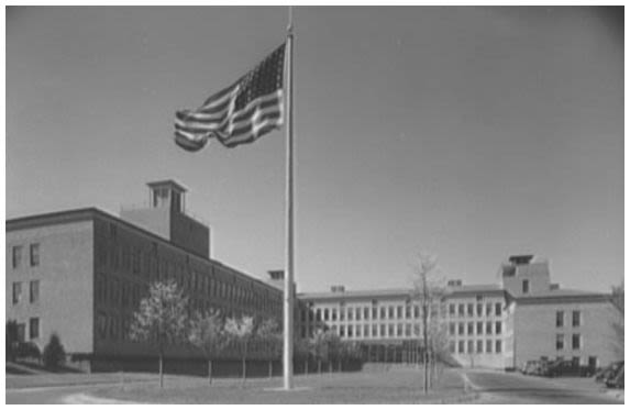 Exterior view of Bell Telephone Laboratories building with trees and walkway. (Library of Congress/Gottscho-Schleisner)
