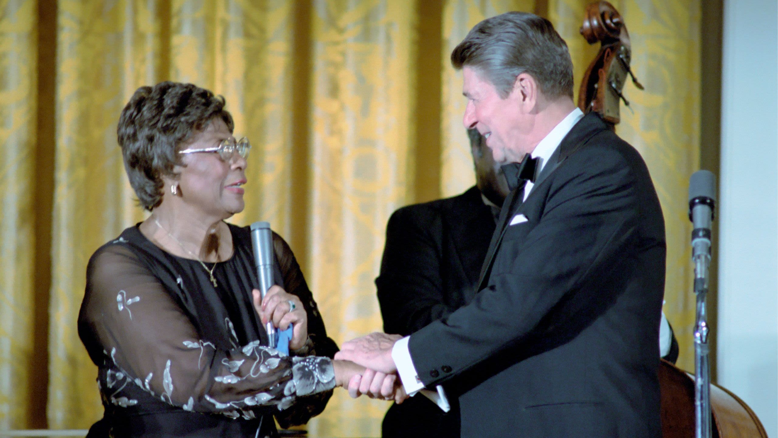 Ronald Reagan holding Ella Fitzgerald’s hand with two hands (White House Photographic Office)