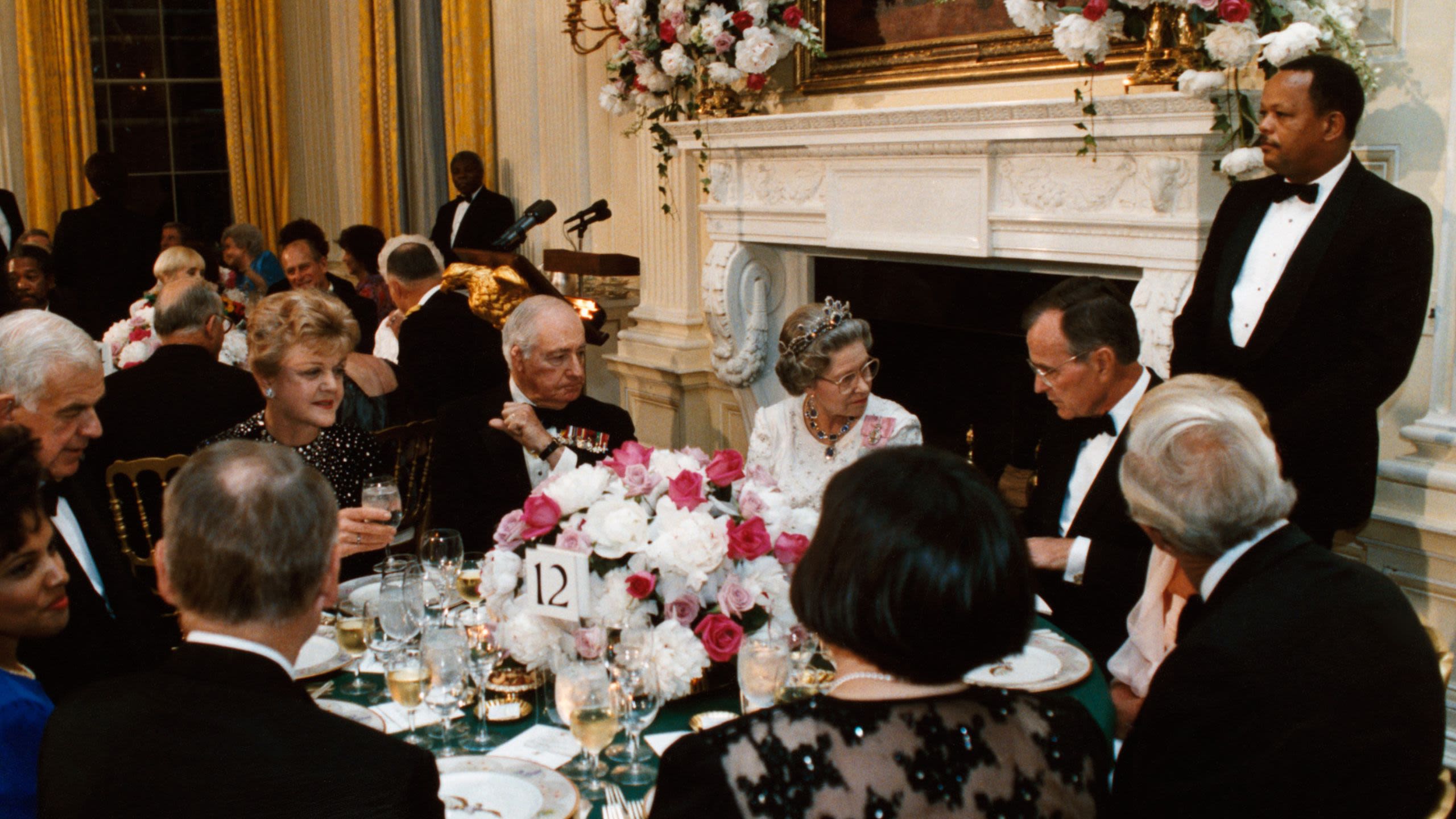 Queen Elizabeth II, George H.W. Bush, others at dinner table (White House)