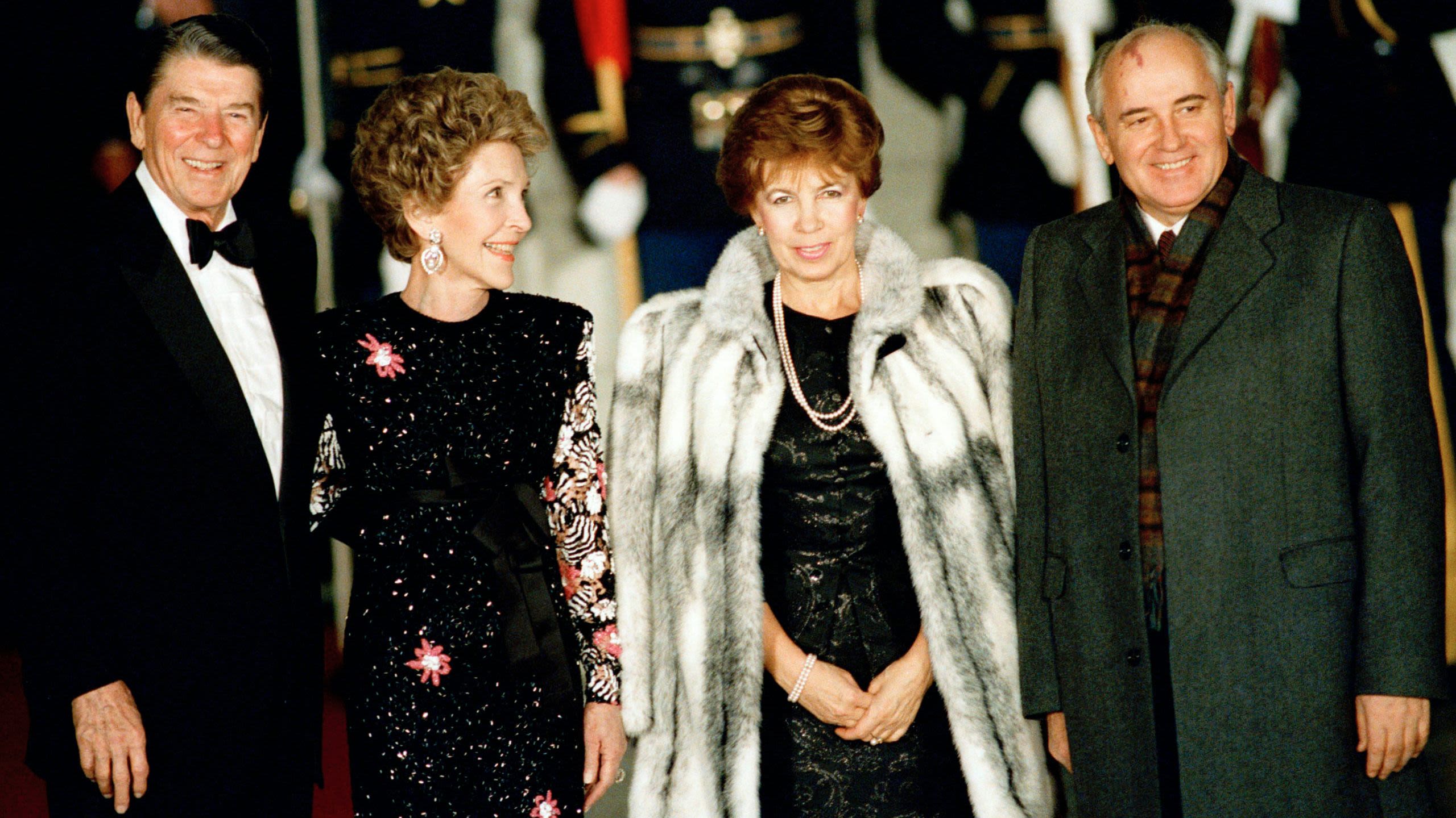 Ronald and Nancy Reagan greeting Mikhail Gorbachev and his wife, Raisa (© Ron Edmonds/AP)
