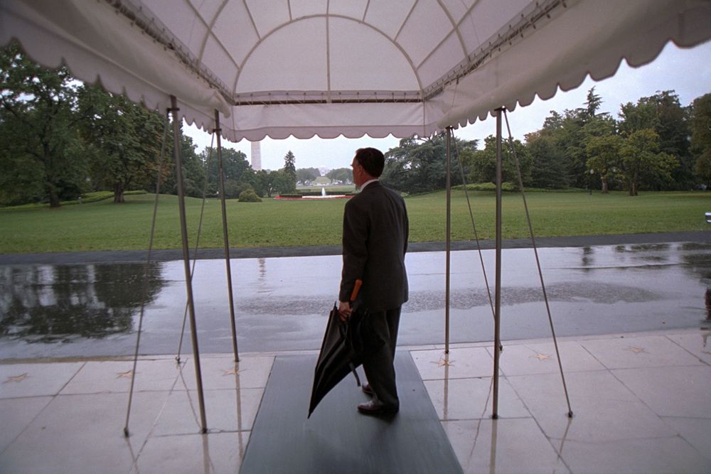 Gary Walters holding umbrella on a wet day at the White House (White House Photographic Office)
