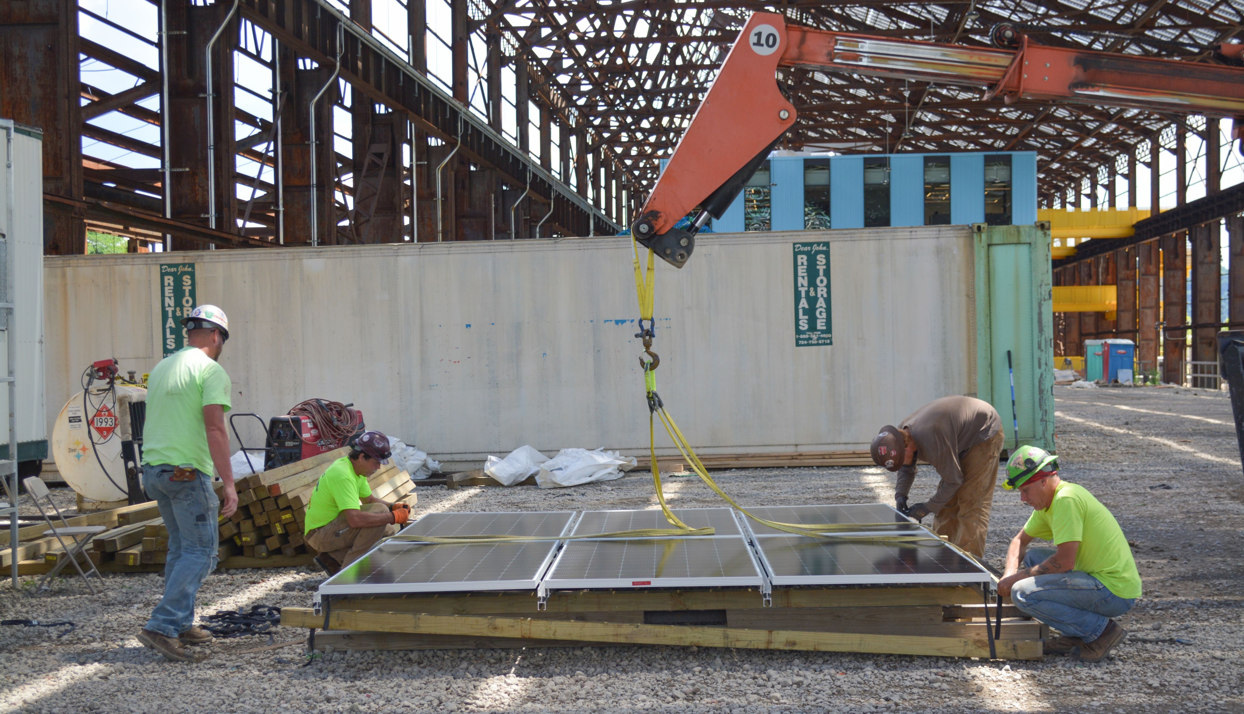 Tim Sippey, far right with white hard hat, and crew as the Mill 19 arrays are being prepared to be hoisted onto the roof, June 2020.