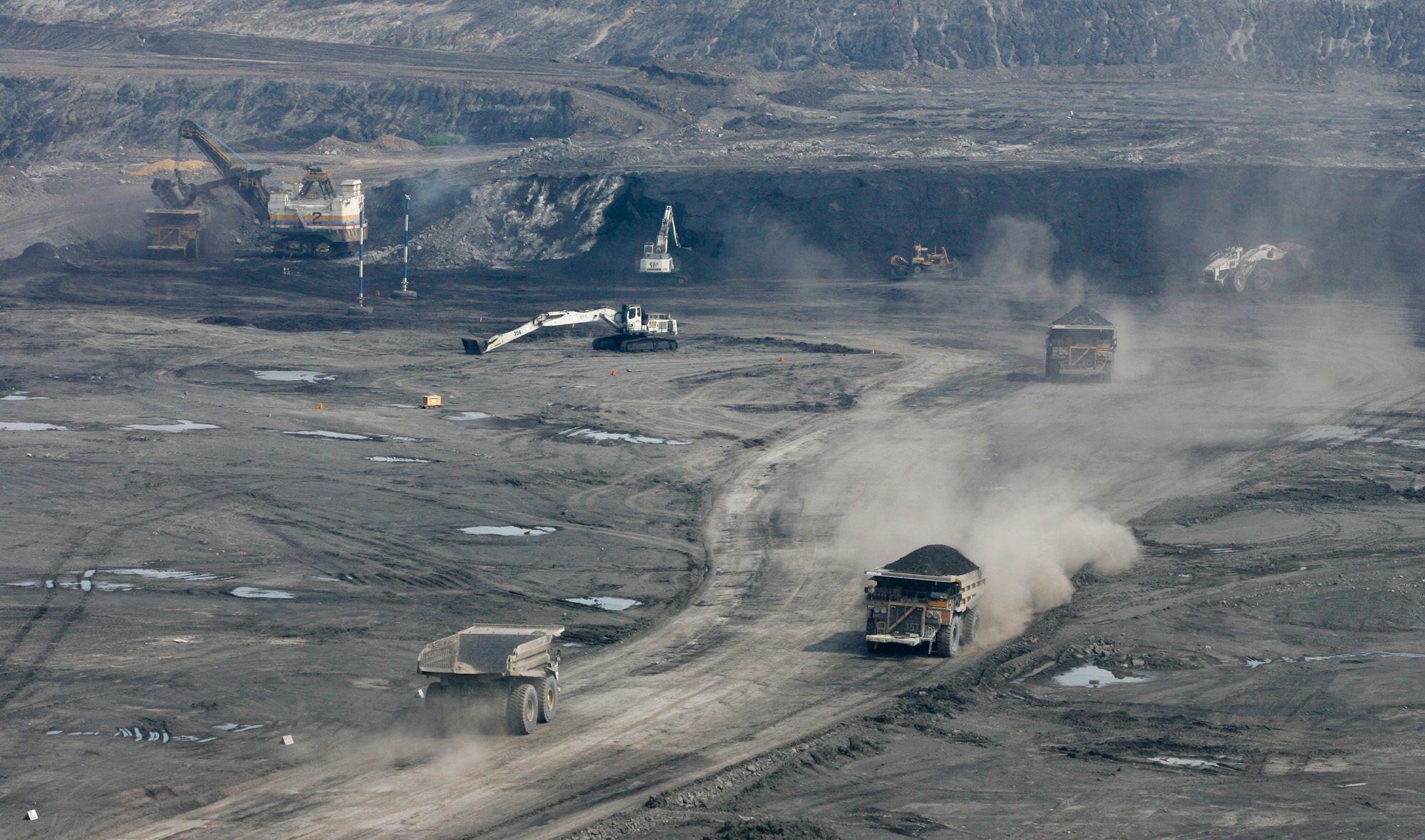  Trucks carry coal from a pit in Cerrejon, Colombia, the world's biggest open-pit export coal mine, in the Guajira peninsula in northern Colombia, Tuesday, May 24, 2005.