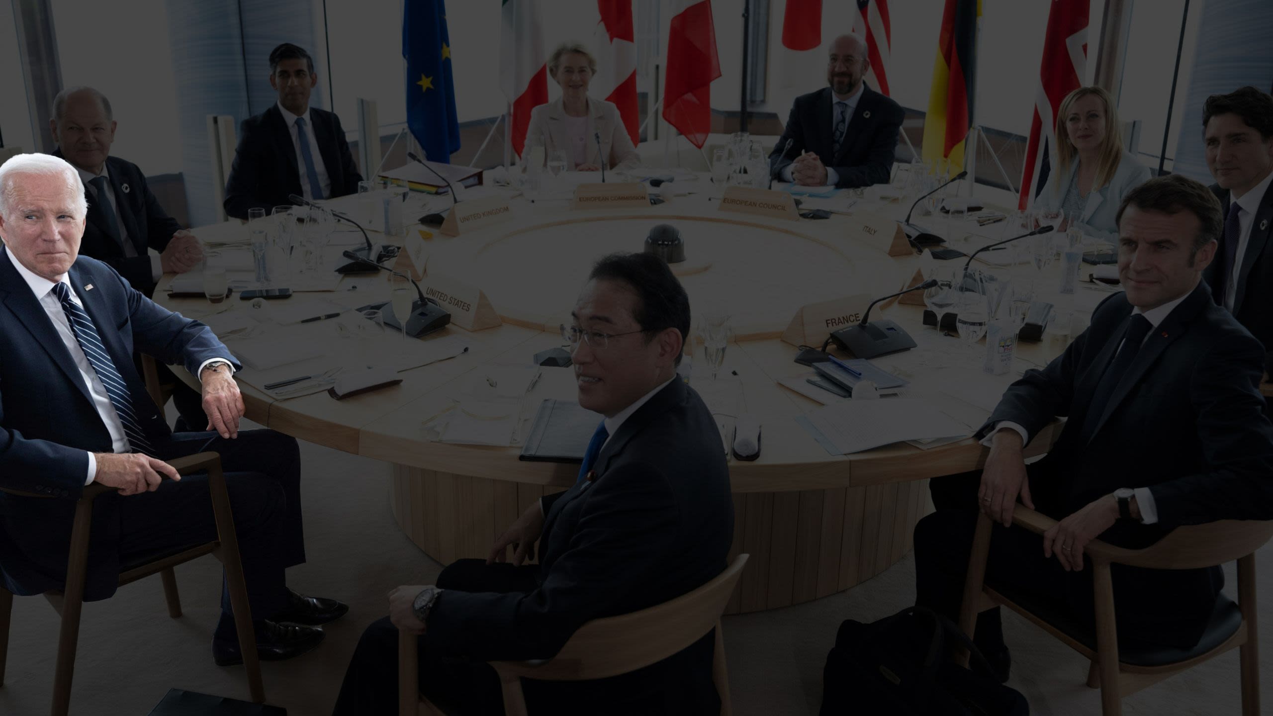 Joe Biden, highlighted, seated at round table with others (© Brendan Smialowski/AP)
