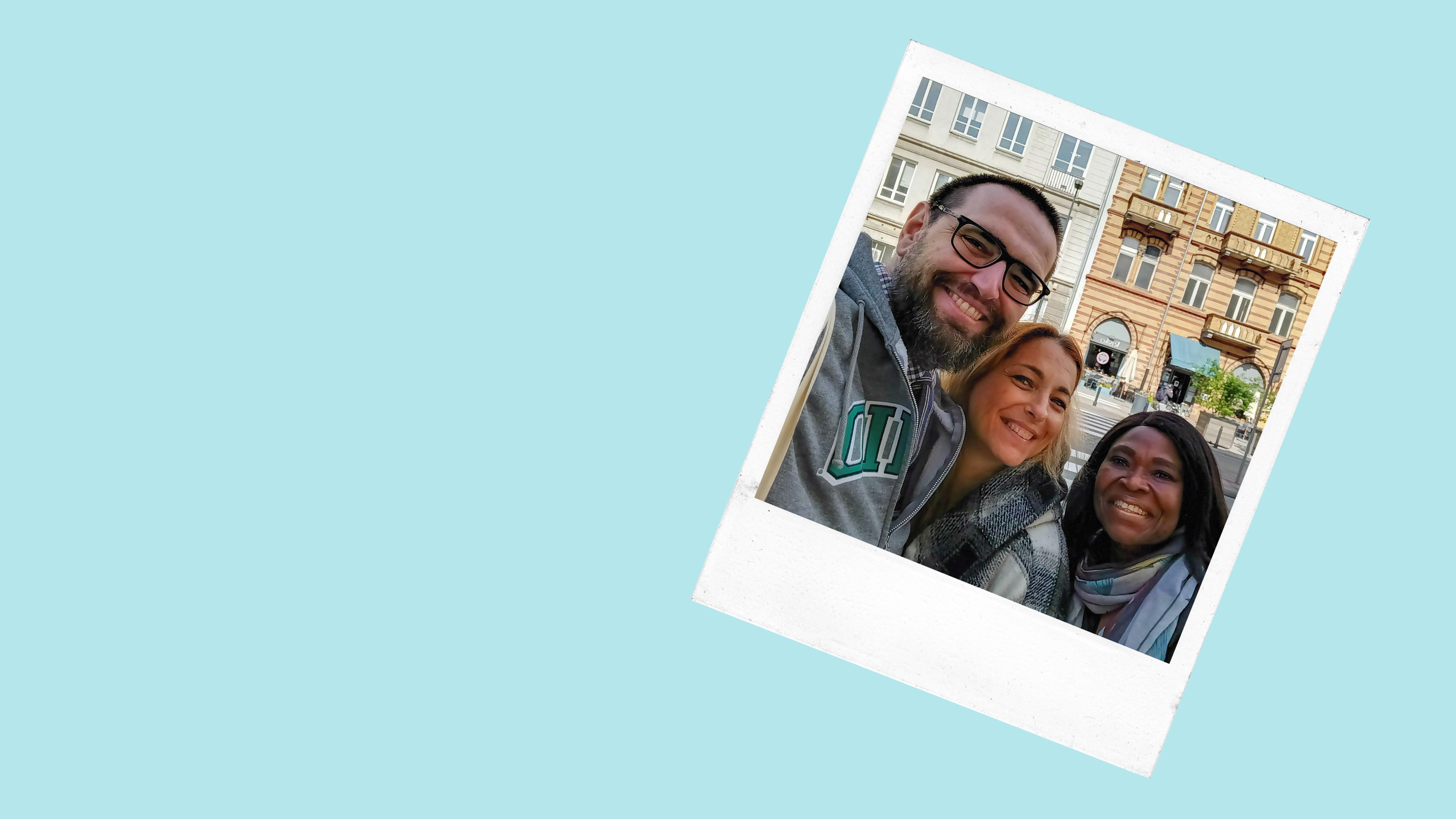 a man and two women smiling
