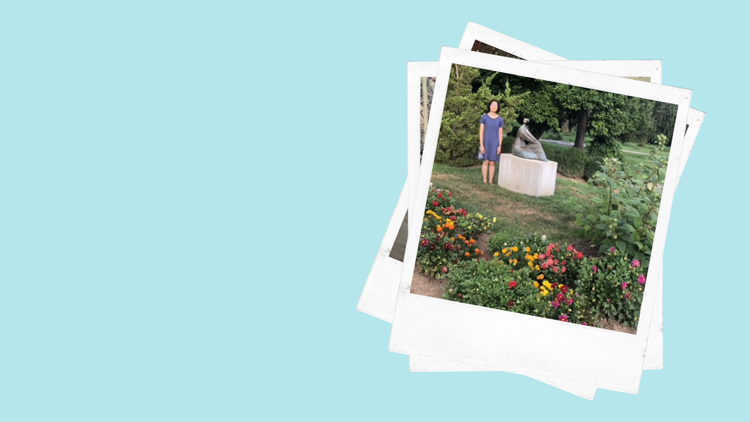 a woman stands next to a large sculpture with many different flowers in the foreground