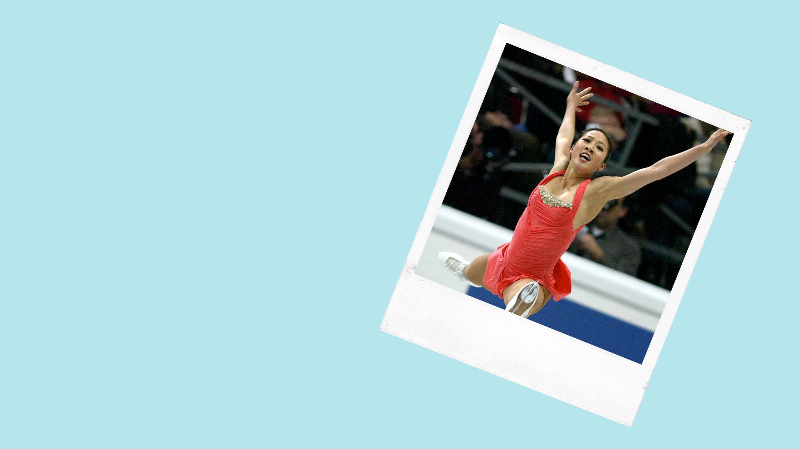 a female figure skater jumps through the air