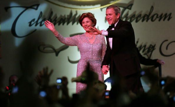 George W. Bush and Laura Bush waving to the crowd at an inaugural ball (© Mario Tama/Getty Images)