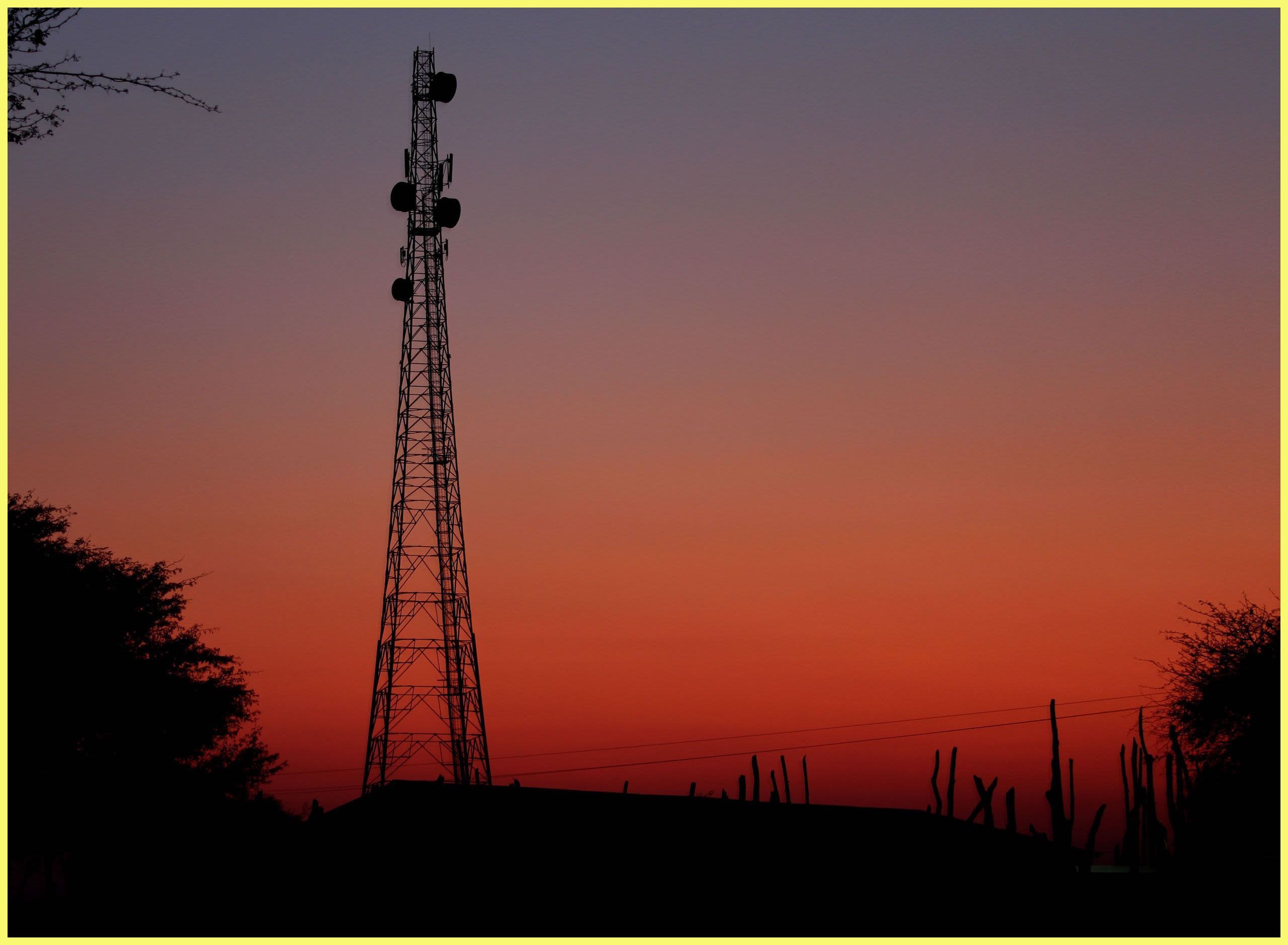Telecommunications tower at sunset (© Rebecca Coles/Alamy)