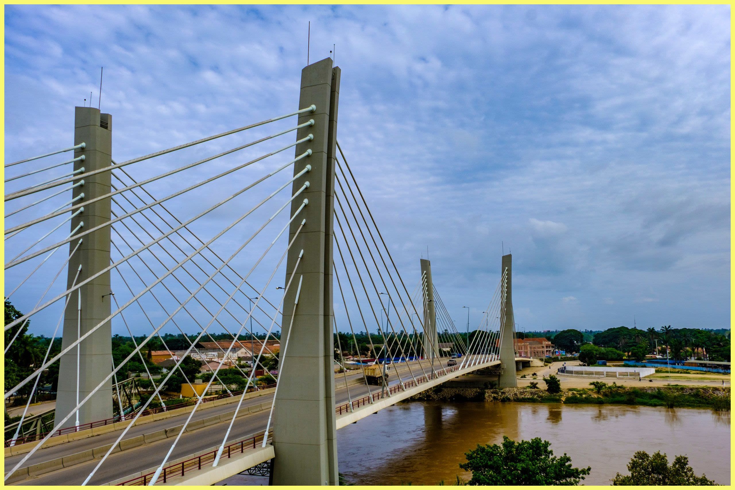 A modern suspension bridge crossing a river (© osn123/Shutterstock.com)