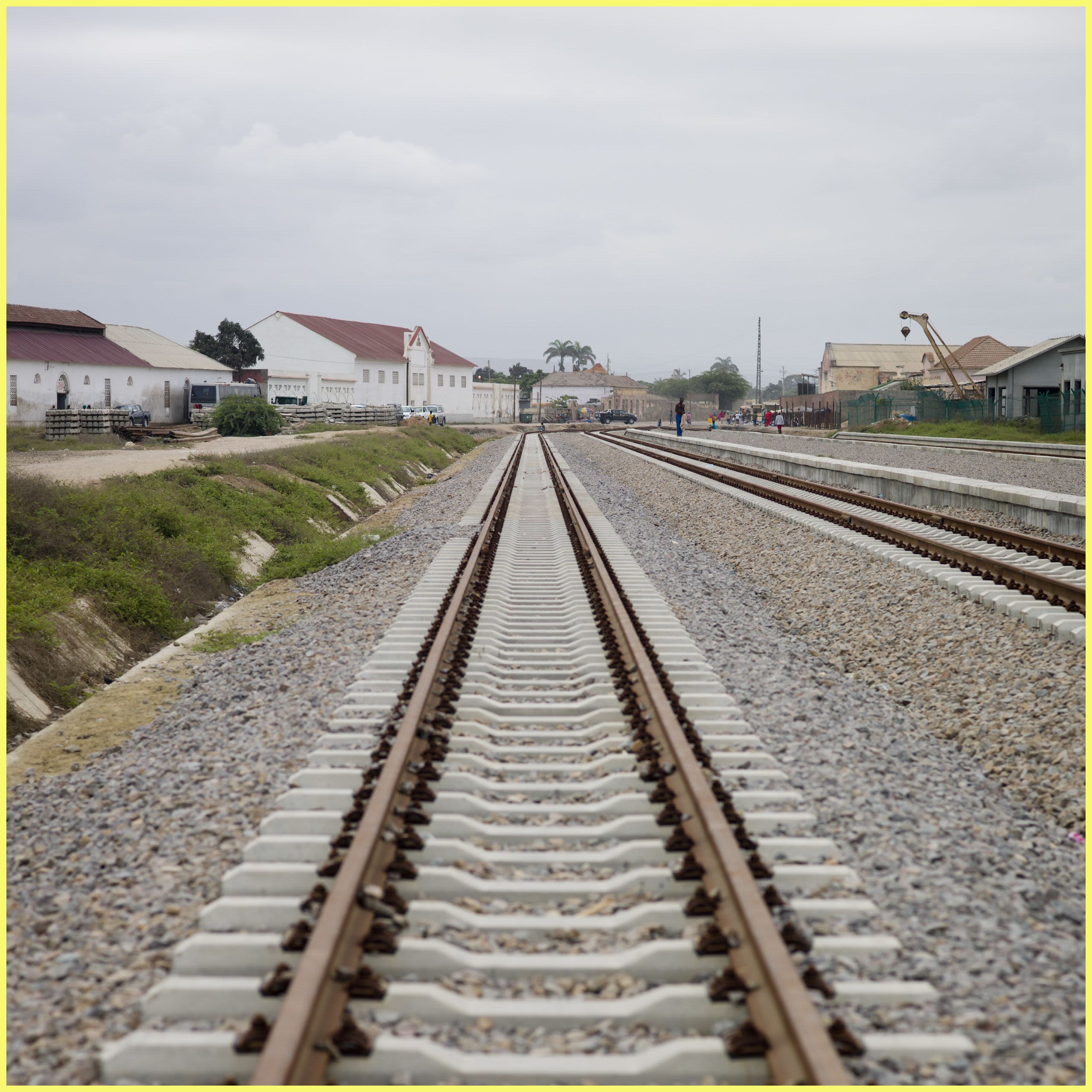 Low angle of train tracks leading to a town (© Eric Laffourgue/Gamma-Rapho/Getty Images)