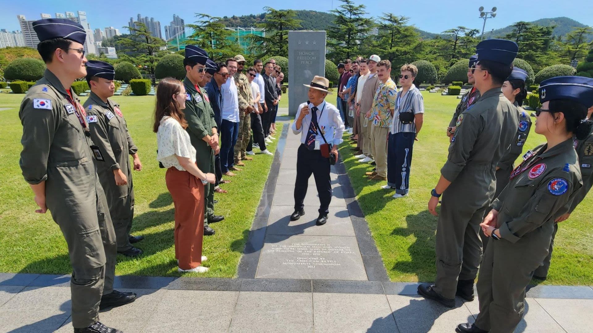 Group of people standing around the U.S. Korean War Monument at Busan (U.S. Air Force/Staff Sergeant Tristan Truesdell)