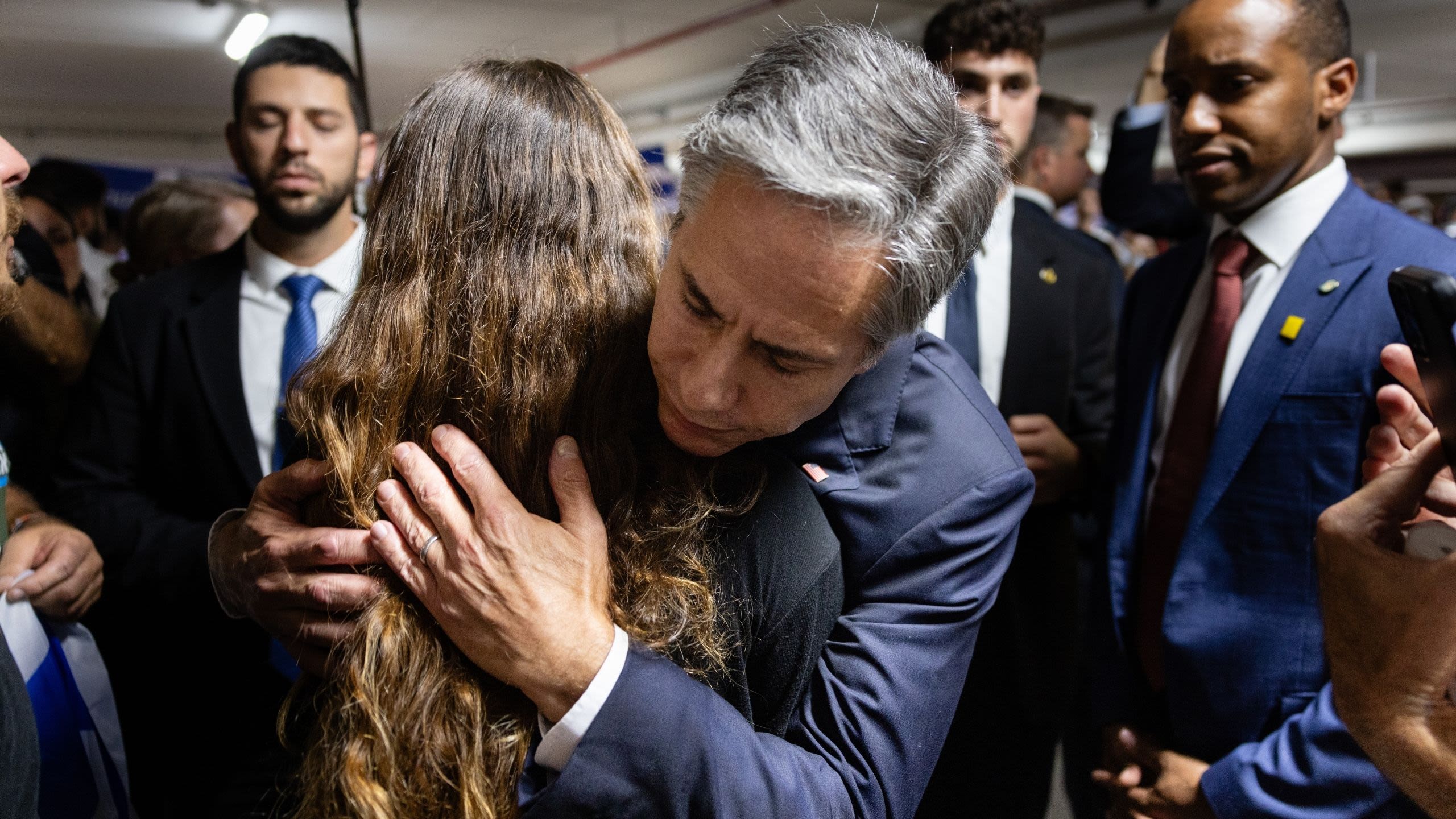 Secretary Blinken hugging a woman