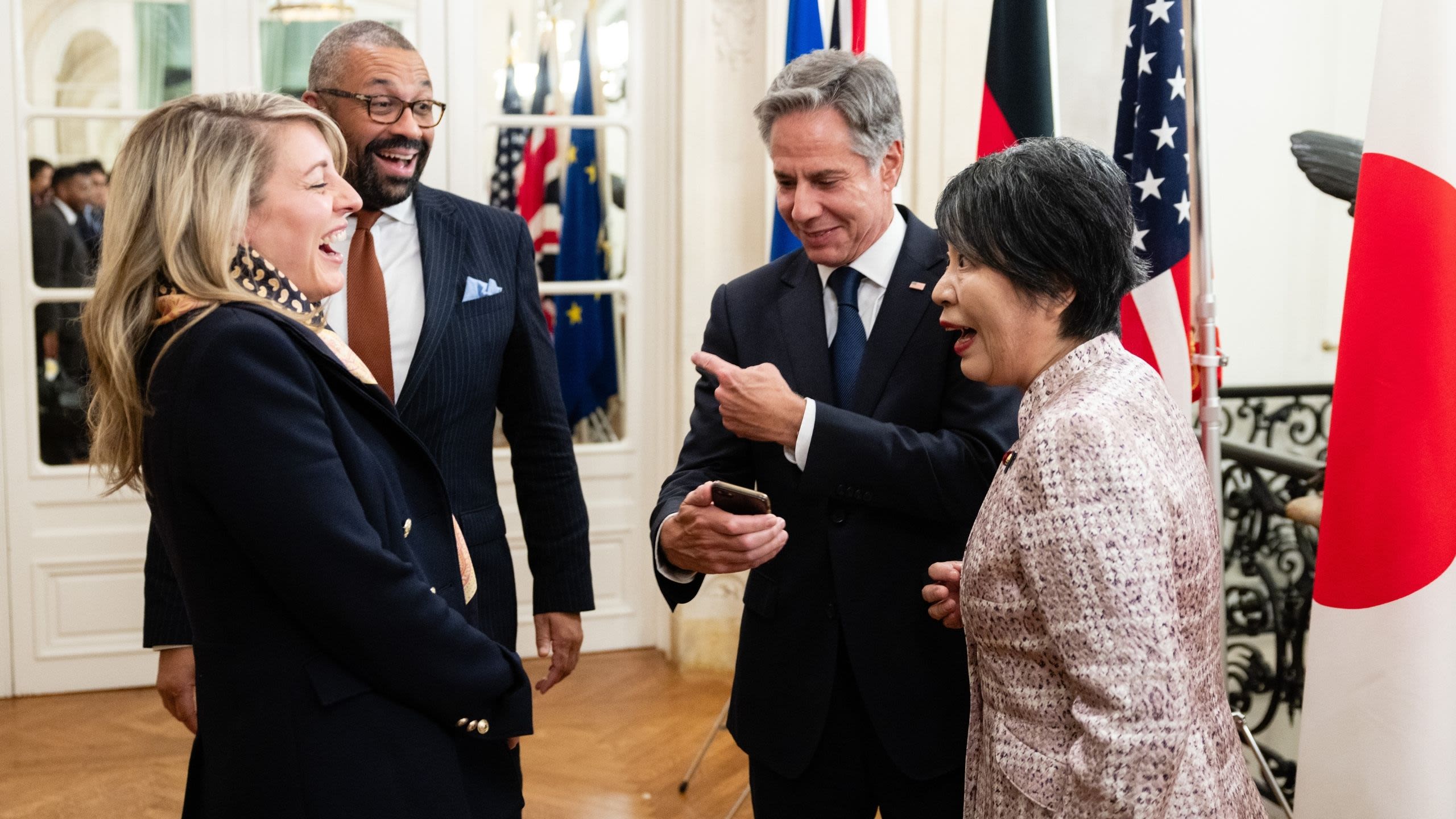 4 people laughing in a room