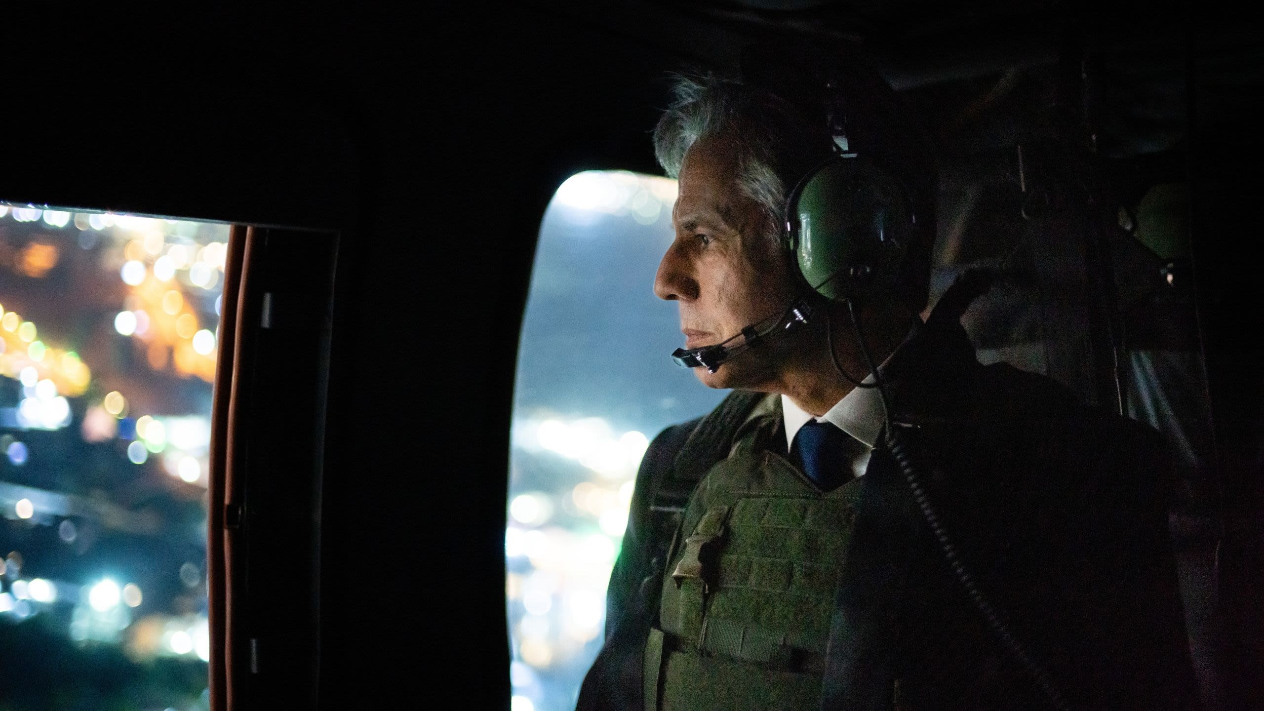 Secretary Blinken looking out a helicopter window
