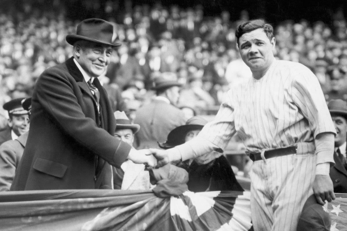President Warren G. Harding shaking hands with New York Yankees baseball player Babe Ruth in crowded baseball stadium (© Bettmann/Getty Images)