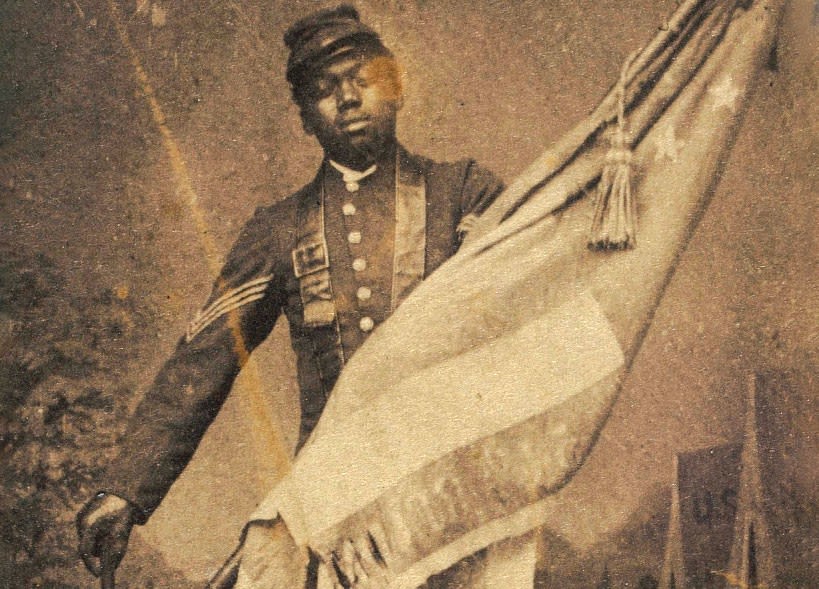 Historic photograph of Sergeant William H. Carney holding a U.S. flag during the Civil War (Army photo)
