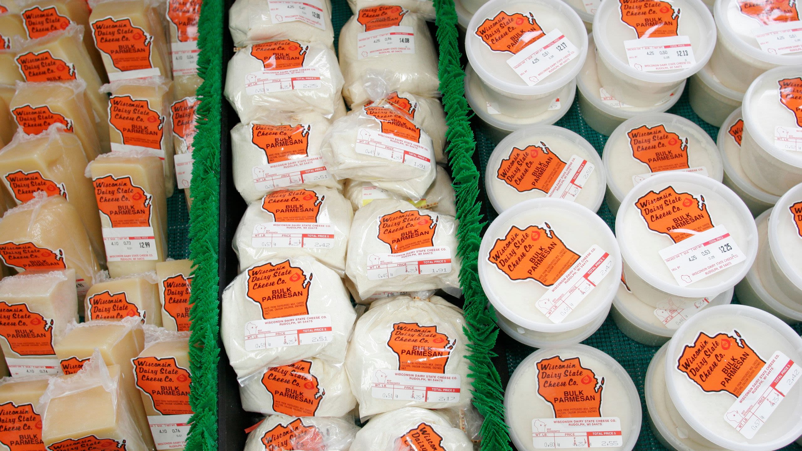 Various packages and containers of cheese displayed for sale (© Jeffrey Greenberg/Universal Images Group/Getty Images)