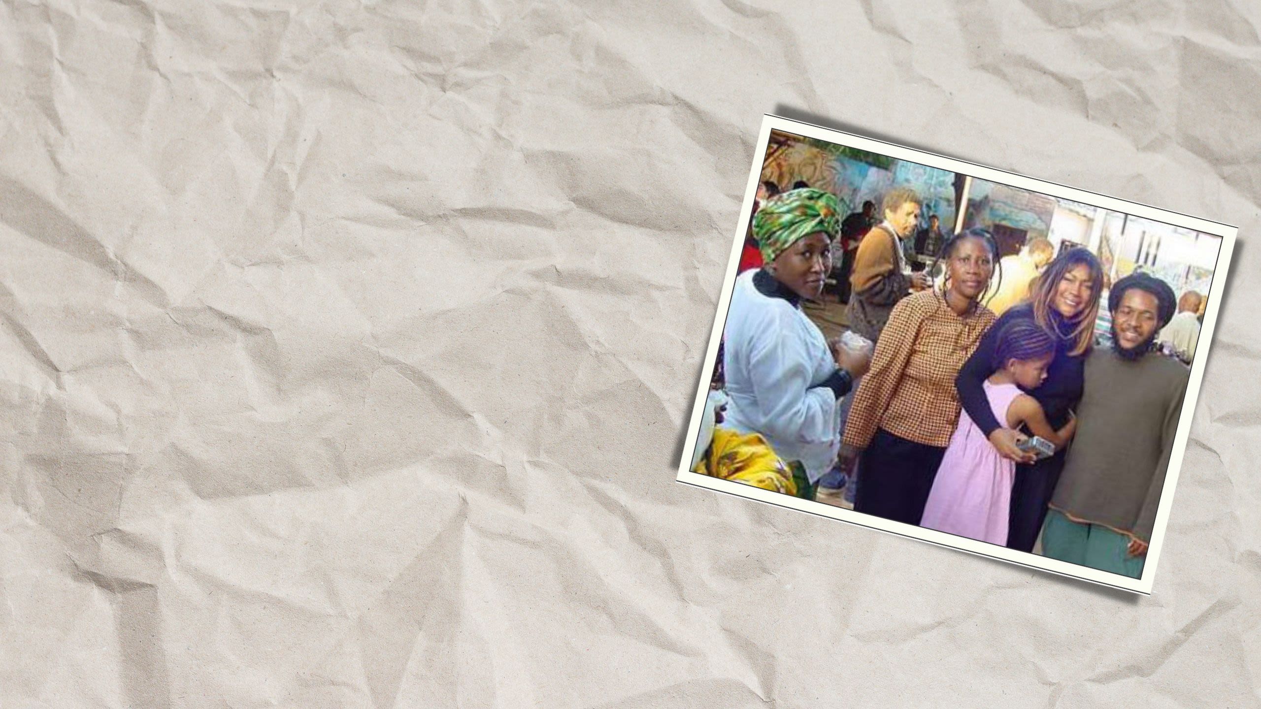 Woman posing for a photograph with a group of people (U.S. Embassy Maputo)