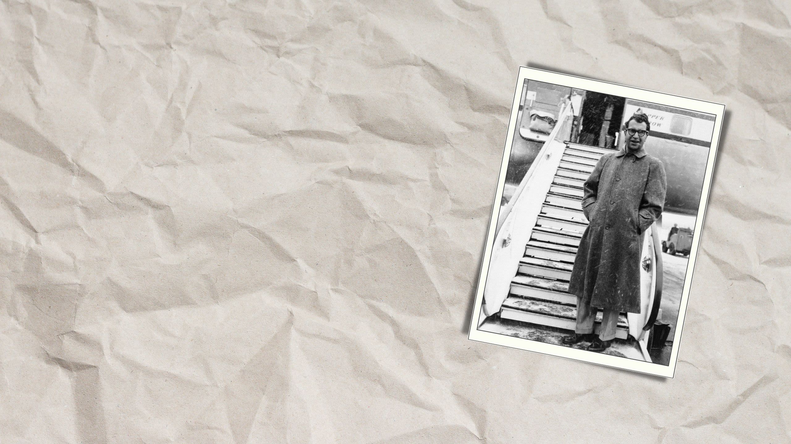 A man standing in front of set of stairs leading up to an airplane (© AP)