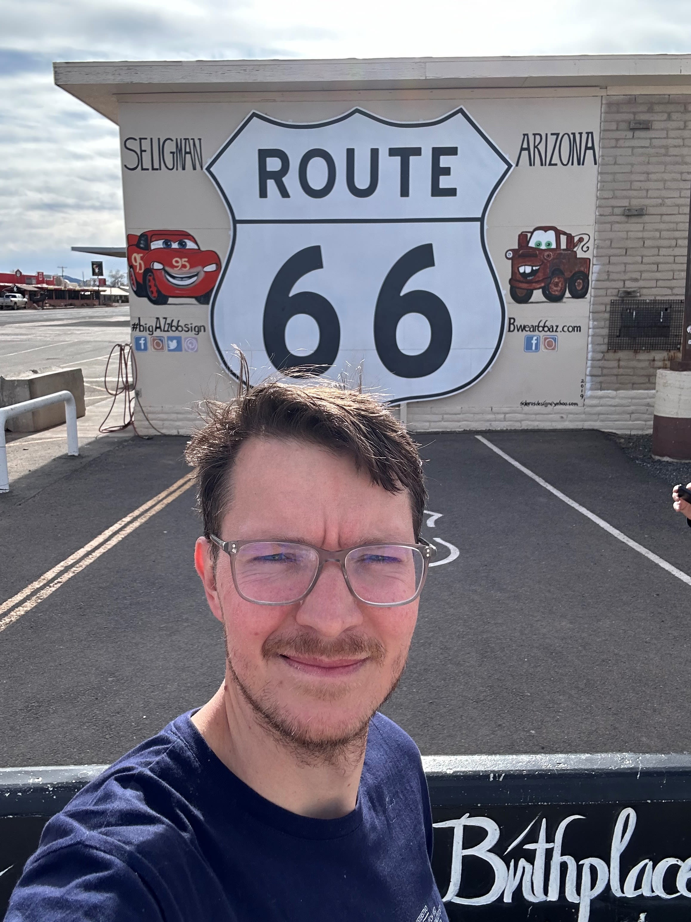 a man standing in front of a Route 66 road sign (Courtesy of Matúš Huťka)
