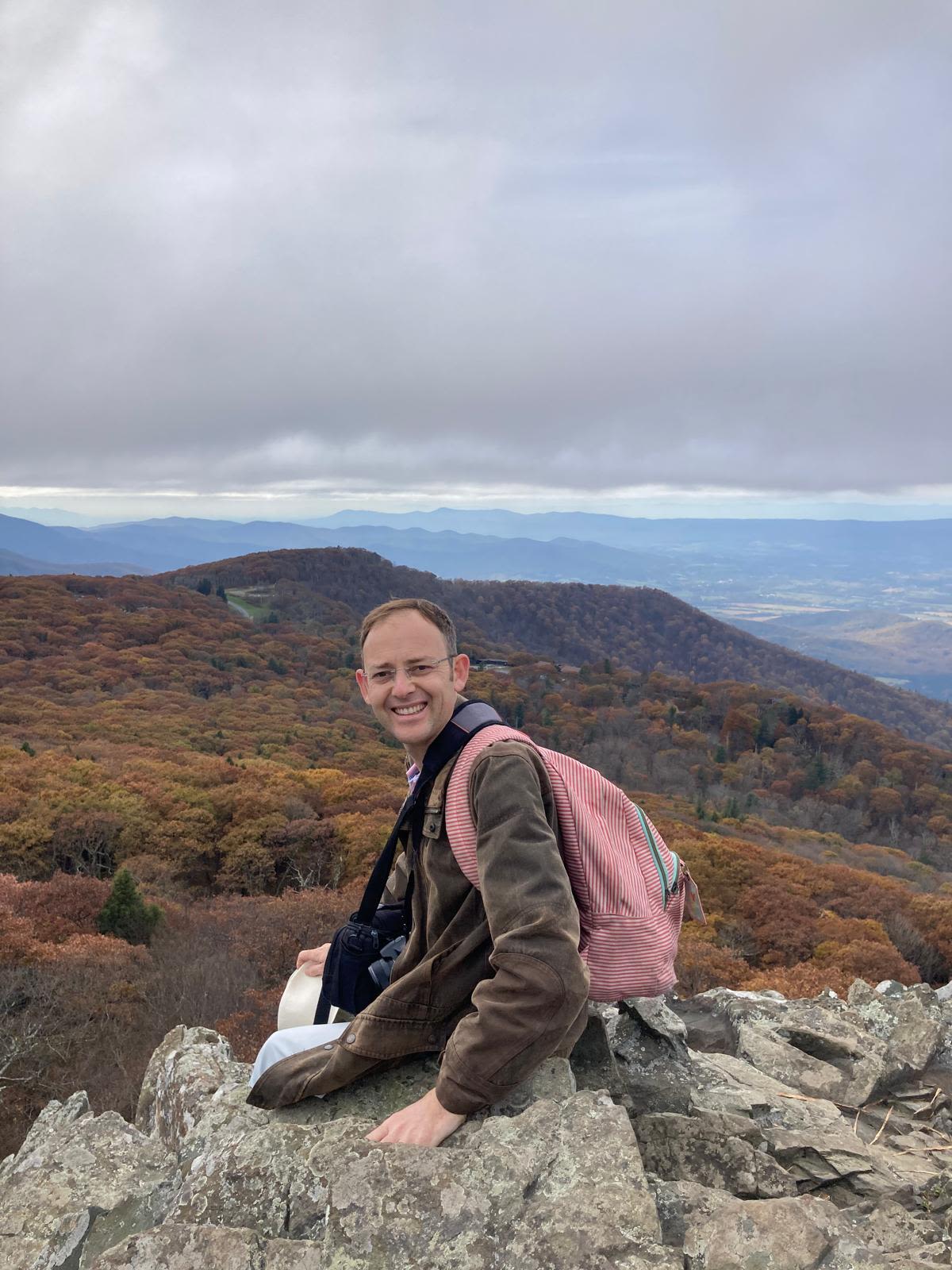 Man sitting on a rocky ledge (Courtesy of Sébastien Fagart)