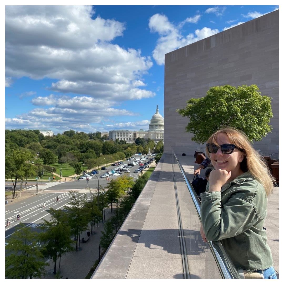 Woman smiling on a balcony overlooking the U.S. Capitol building (Courtesy of Rūta Beinoriūtė)