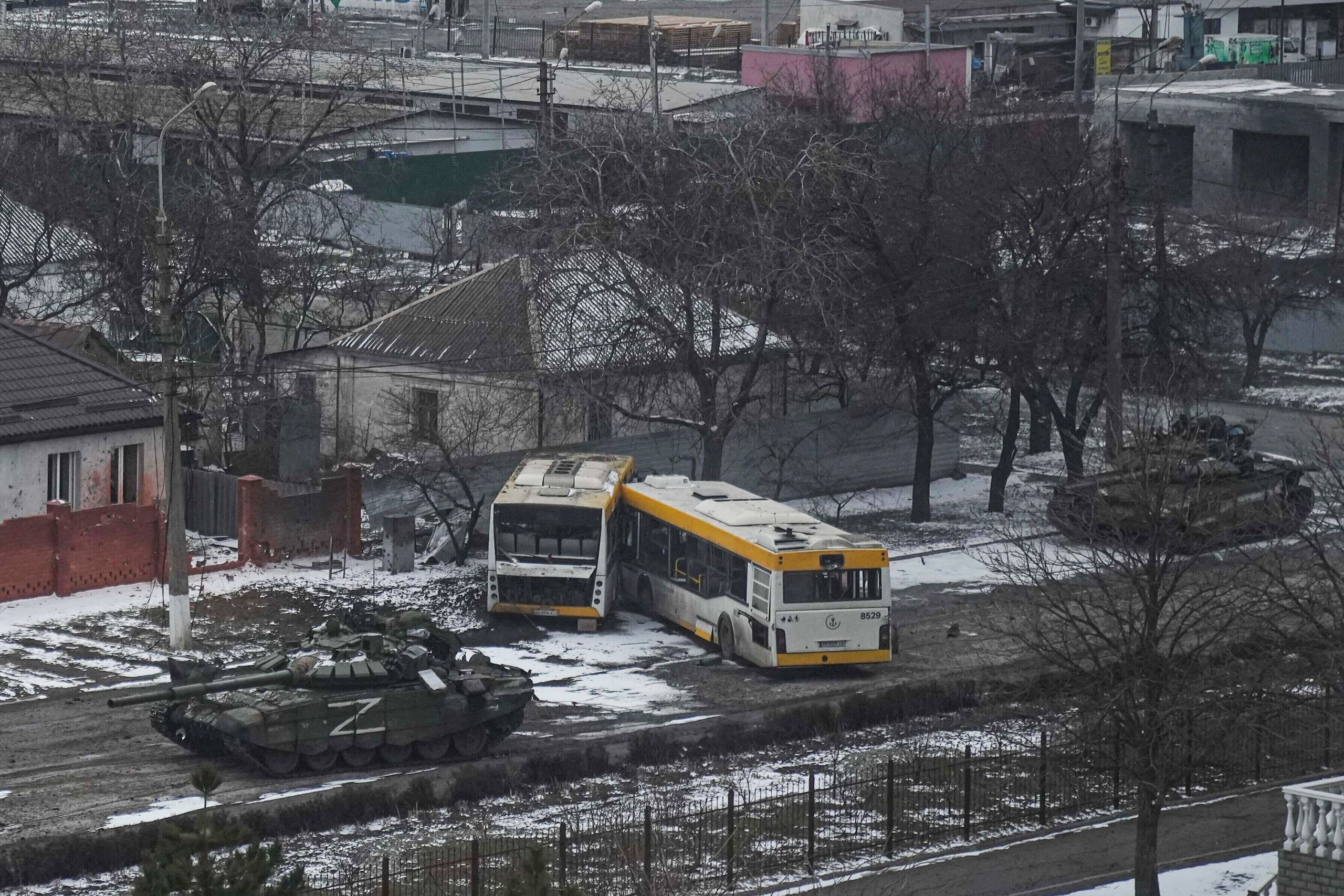 Russian tanks move down a street on the outskirts of Mariupol, Ukraine, on March 11, 2022. (© Evgeniy Maloletka/AP Images)