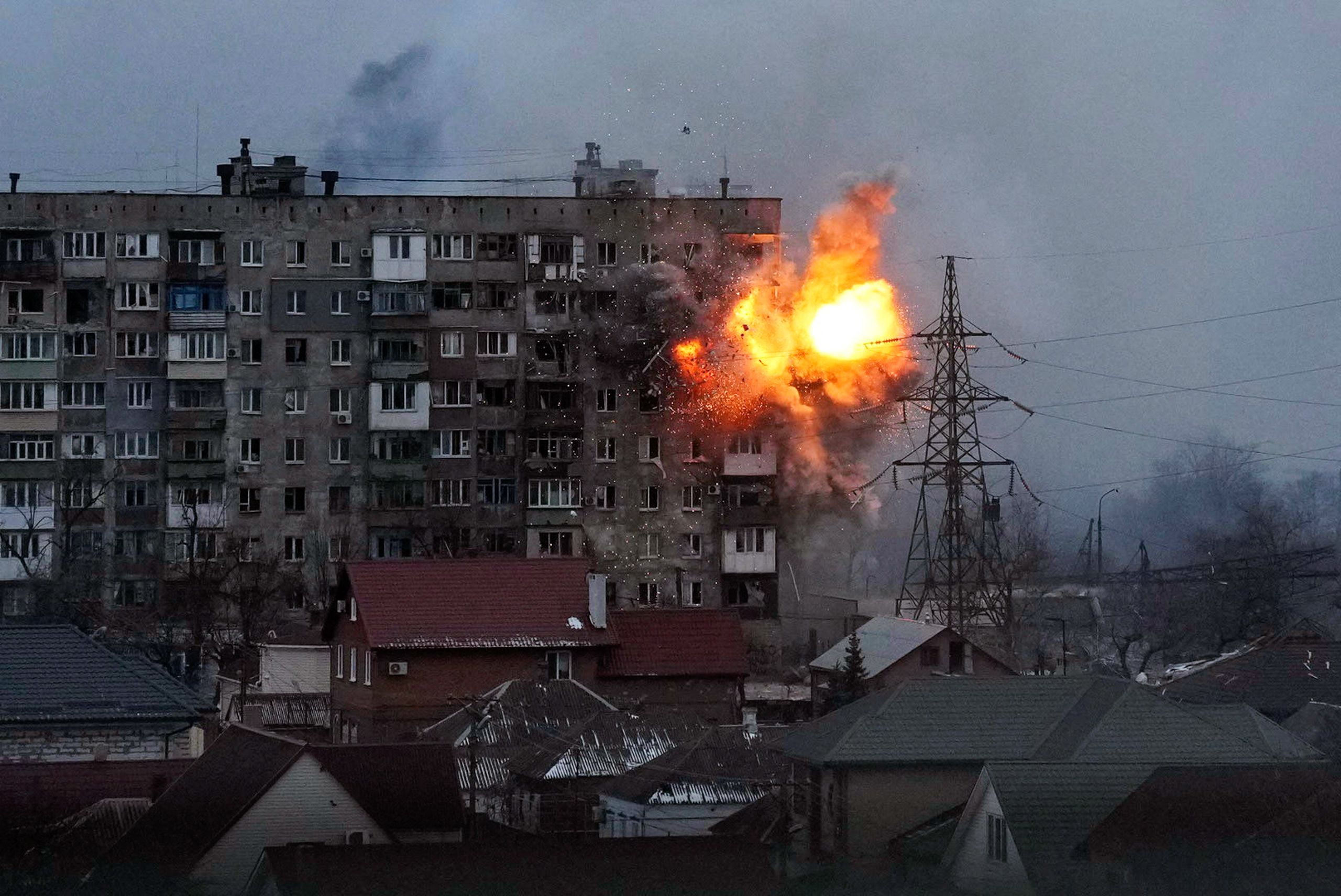 An explosion is seen in an apartment building after a Russian army tank fires in Mariupol, Ukraine, on March 11, 2022. (© Evgeniy Maloletka/AP Images)